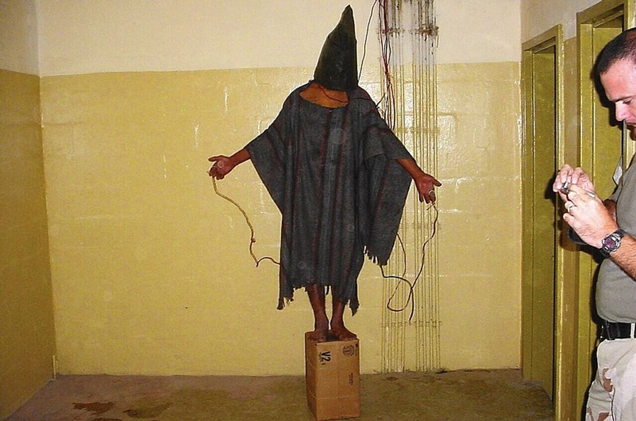 hooded detainee imprisoned at Abu Ghraib